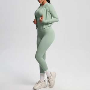 Detailed view of the side-profile fit of a light green yoga three-piece suit and jacket