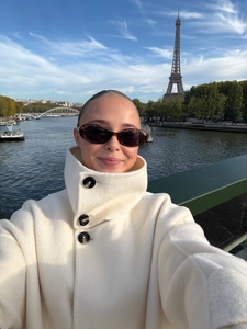Detail of white wool coat with stand collar and large buttons set in a Paris street scene