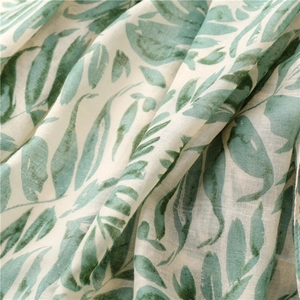 Detail of green banana leaf print fabric with soft texture and elegant draping effect