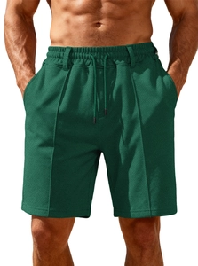 Detail of dark green textured knit shorts with elastic drawstring waist and pocket design