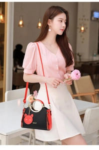Fashionable black and red tote bag with cat face decor and golden ring handle