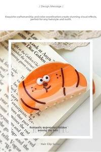 Close-up of orange croissant dog hair claw clip on a vintage magazine and lace background