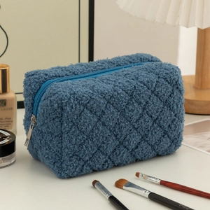 Detail of blue quilted fleece pencil case with silver zipper in a lifestyle setting