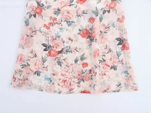 Detailed macro view of lightweight floral chiffon fabric with red and pink flower patterns