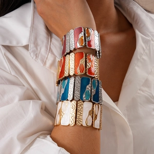 Close-up of retro geometric enamel stretch bracelets in vibrant red and blue colors