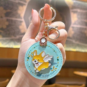 Cute blue leather Corgi dog keychain with golden hardware and enamel wing charm
