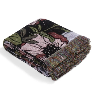 Couverture jacquard nordique à motif floral avec pompons colorés sur fond blanc