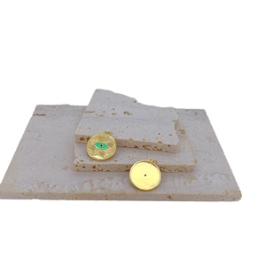 Retro gold plated evil eye pendant necklace for women on minimalist stone background