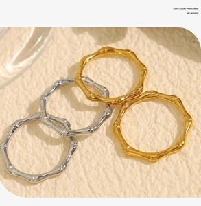 Macro view of gold and silver bamboo motif rings with minimalist textured finish