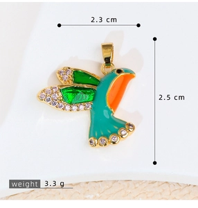 Detailed view of hummingbird pendant with green enamel and measurements 2.3x2.5 cm