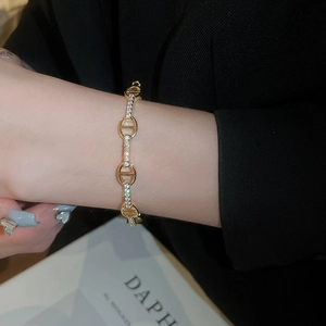 Close-up of gold plated H-shaped bracelet featuring sparkling pave-set cubic zirconia