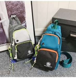 Detail view of multi-pocket crossbody bags with zippers and woven drawstrings