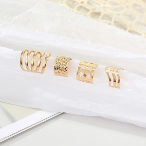 Set of four gold hollow star ear bone clips with minimalist wave and textured designs