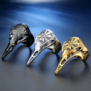 Close-up of Norse Viking bird skull rings in black, silver, and gold stainless steel