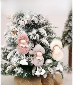 Detailed close-up of three plush angel Christmas tree ornaments with sequins and stars
