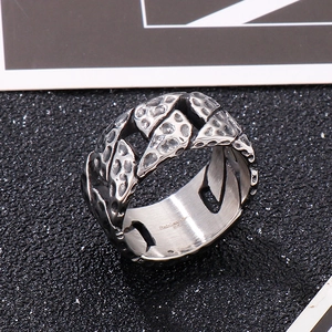 Macro view of vintage Cuban chain ring with hammered texture and oxidized finish