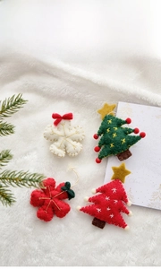 Wool felt Christmas ornaments including snowflake and tree shapes with festive embroidery