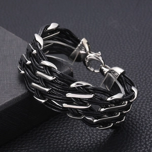 Close-up of woven black leather cord and stainless steel industrial link bracelet for men
