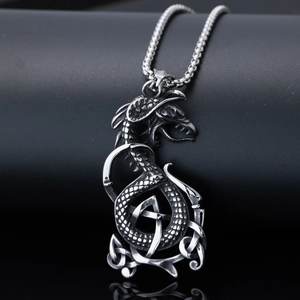 Macro detail of silver dragon pendant necklace featuring intricate Celtic knot patterns