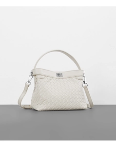 Detail of cream woven leather handbag featuring silver metal clasp and fine texture