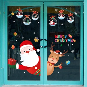 Christmas window stickers featuring Santa Claus and reindeer on a glass door display