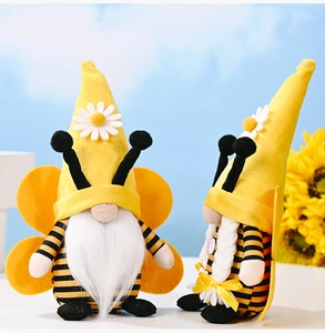 Detail of bee themed gnome plushies with yellow wings and daisy flowers on hats