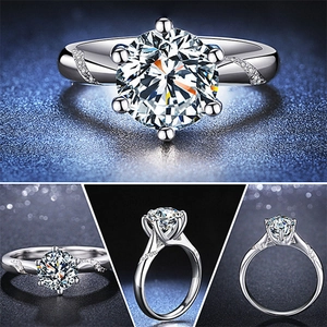 Classic six-prong moissanite ring with round cut center stone and pavé diamond band
