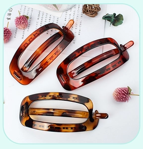 Close-up of tortoise shell pattern rectangular hollow hair clips in three classic colors