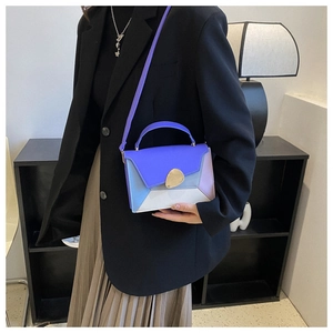 Close-up of color-block crossbody bag in purple, blue, and white worn by a model