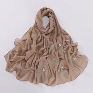 Detailed view of brown chiffon hijab with elegant floral pearls and rhinestone embellishments