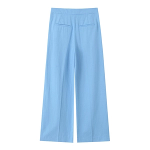 Detail view of sky blue wide-leg trousers showing back pocket stitching and smooth fabric