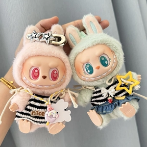 Close-up of plush dolls in pink and green striped outfits with cute star accessories
