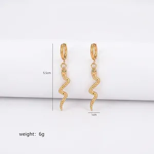 Detail of gold snake drop earrings with scale texture and green zircon eyes, 5.5cm long