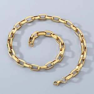 Close-up of golden rectangular link chain with a secure lobster clasp on gray background