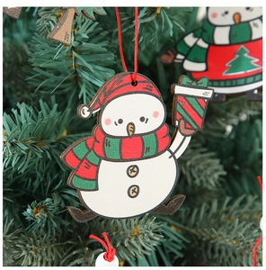 Detailed view of a wooden snowman ornament with a red hat hanging on a Christmas tree branch