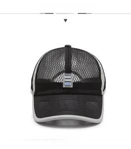 Close-up of breathable black honeycomb mesh fabric on a sporty baseball cap with grey piping