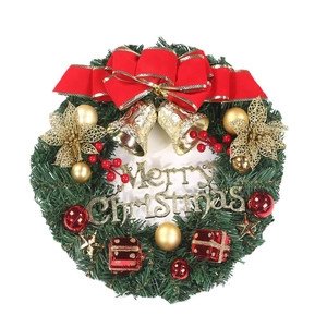 Artificial Christmas wreath with red bows, golden bells, and Merry Christmas sign