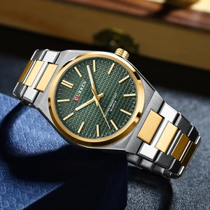 Detail of silver and gold men's watch with deep green checkered dial in wood box