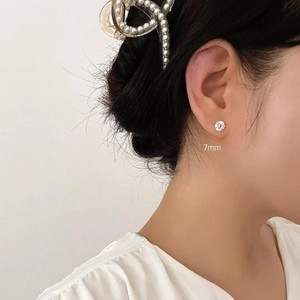 Close-up of 7mm cubic zirconia stud earring showing real-life wearing effect on ear