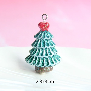 Macro shot of resin Christmas tree pendant with glitter finish and 2.3x3cm size marker