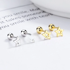 Detail of 925 silver and gold hollow star stud earrings with secure screw-back ball closure