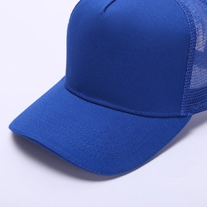 Detail of blue five-panel trucker hat featuring breathable mesh and reinforced visor stitching