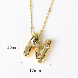 Detailed view of gold letter N pendant with rhinestones measuring 20mm by 17mm