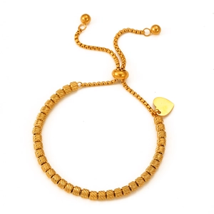Gold beaded heart charm bracelet with adjustable sliding closure and textured sphere beads