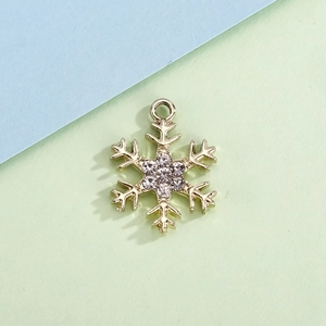 Detailed close-up of a gold snowflake pendant with sparkling inlaid rhinestones