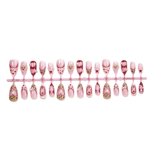 Handmade pink heart press-on nails with 3D bows, pearls, and leopard print patterns