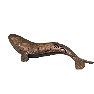 Antique bronze whale incense burner with intricate hollowed-out wave carvings for home decor