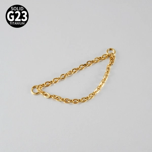 Macro view of gold G23 titanium double chain with secure jump rings for body jewelry