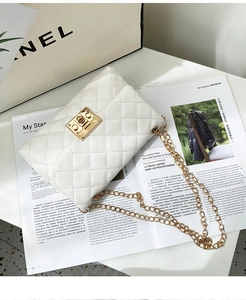 Detail of white quilted crossbody bag with golden rectangular clasp and chain strap