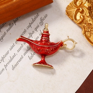 Vintage red enamel Aladdin lamp brooch with golden details and intricate patterns